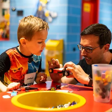 Little boy learning how to build with lego