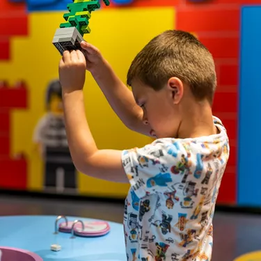Little boy building with lego