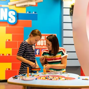 Little girl learning how to build with lego