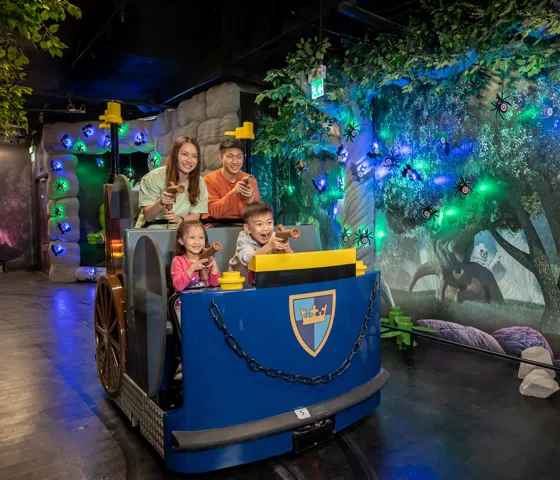 Parents and kids are riding the chariot in the Kingdom Quest ride.