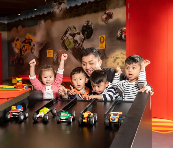 Kids are racing cars againest each other at LEGO® RACER