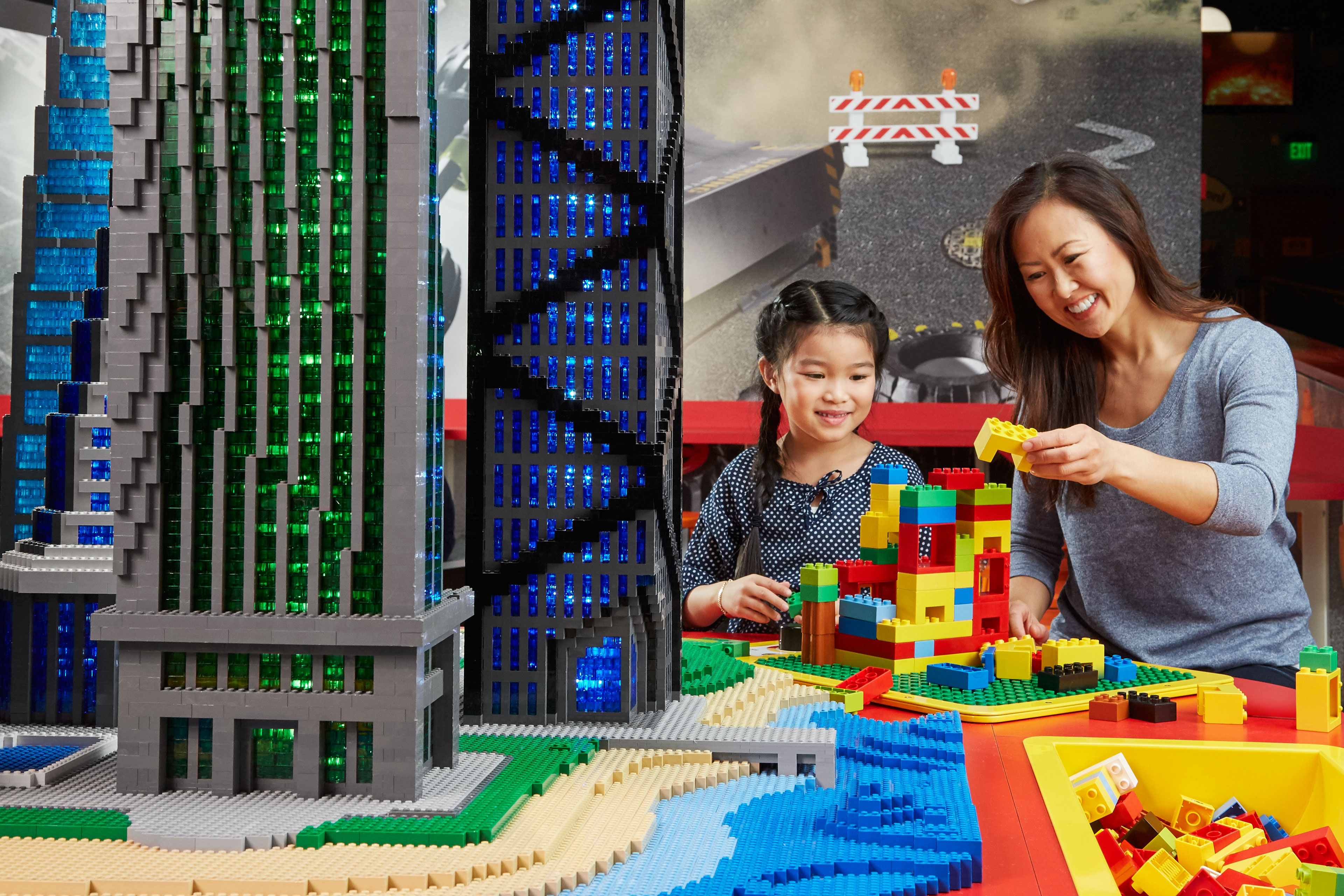 mother and daughter playing with lego