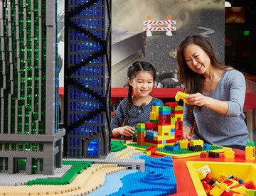 mother and daughter playing with lego