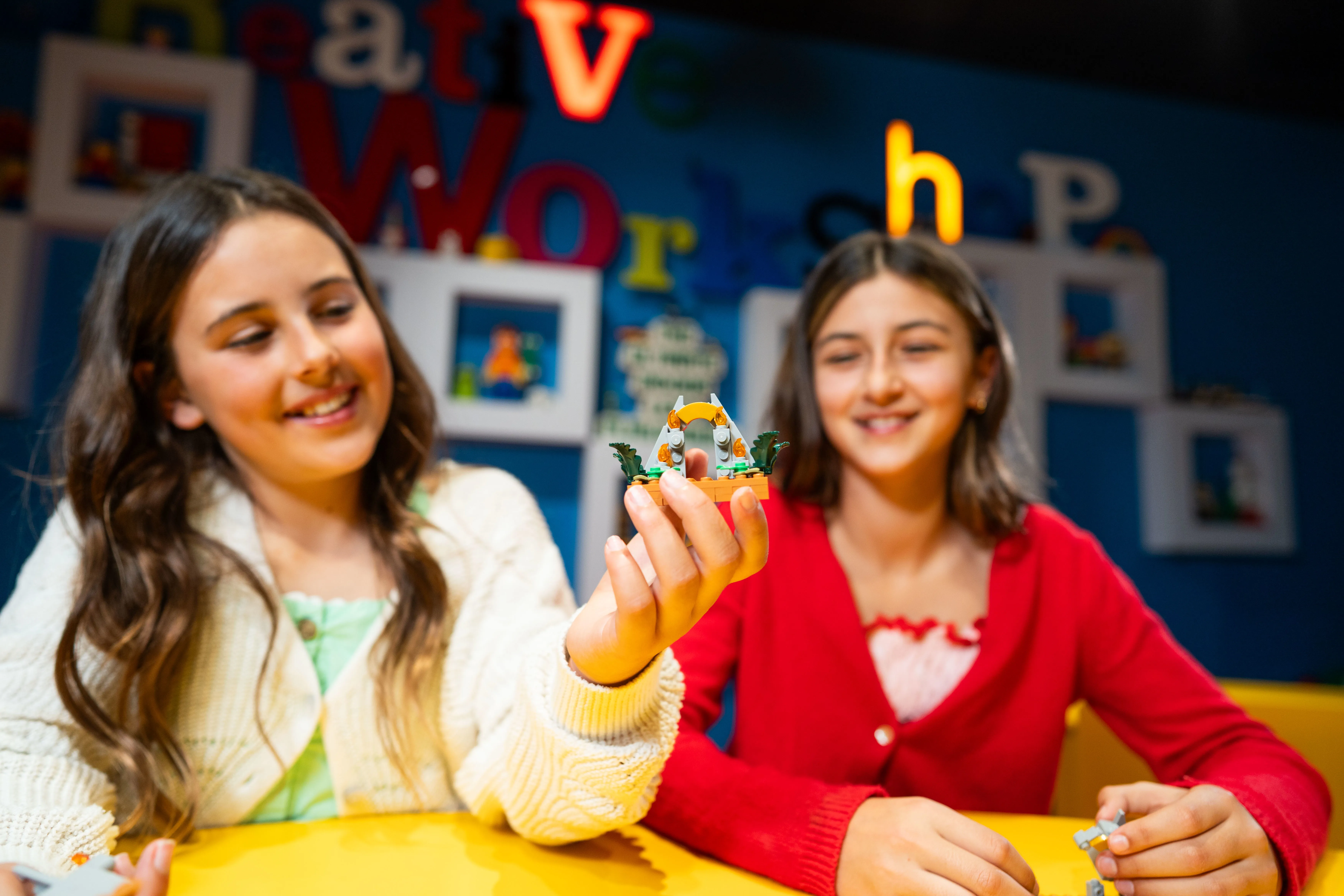 Girl showing her Jurassic Park Gates LEGO creation