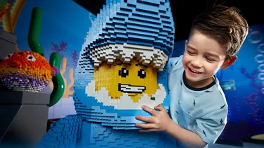 boy with lego figure dressed as shark